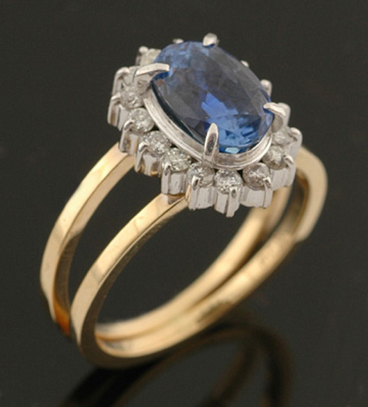 Appraisal: A sapphire and diamond ring The oval design set to