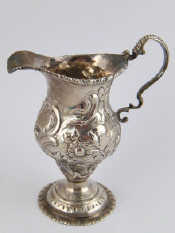 Appraisal: A Georgian silver cream jug on spread foot with original