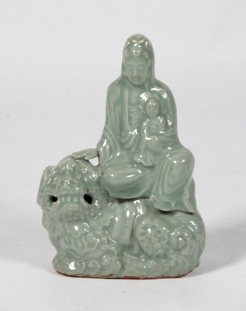 Appraisal: A th Century Chinese celadon figure of Guanyin seated on