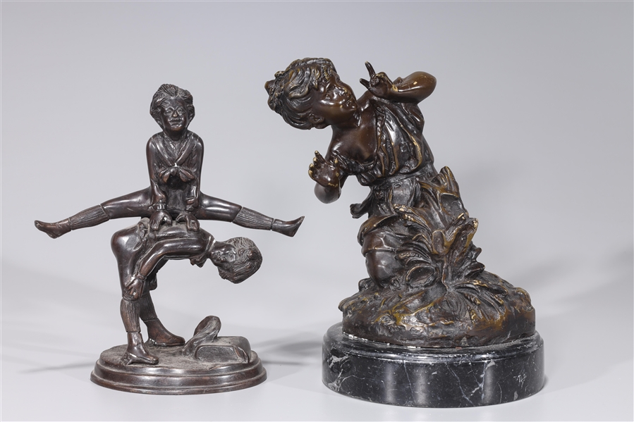 Appraisal: Group of two bronze statues including one of kneeling child