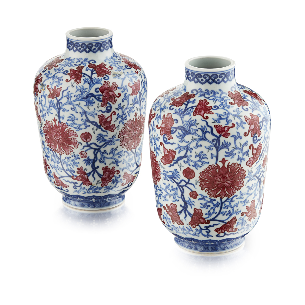 Appraisal: PAIR OF COPPER-RED DECORATED BLUE AND WHITE VASES of ovoid