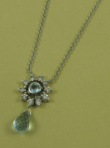 Appraisal: BLUE TOPAZ AND DIAMOND PENDANT NECKLACE the pendant suspended between