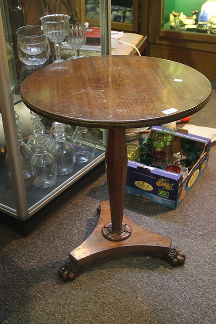 Appraisal: A MAHOGANY OCCASIONAL TABLE with inverted column and triform base