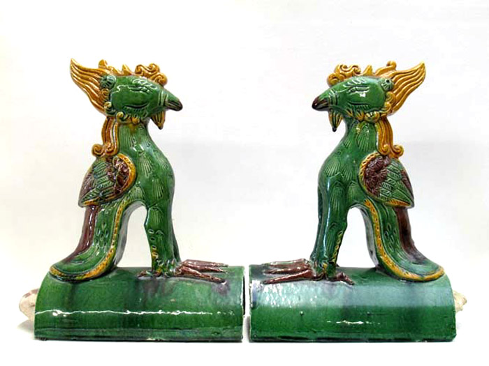 Appraisal: TWO CHINESE POTTERY ROOF TILES of seated winged griffin with