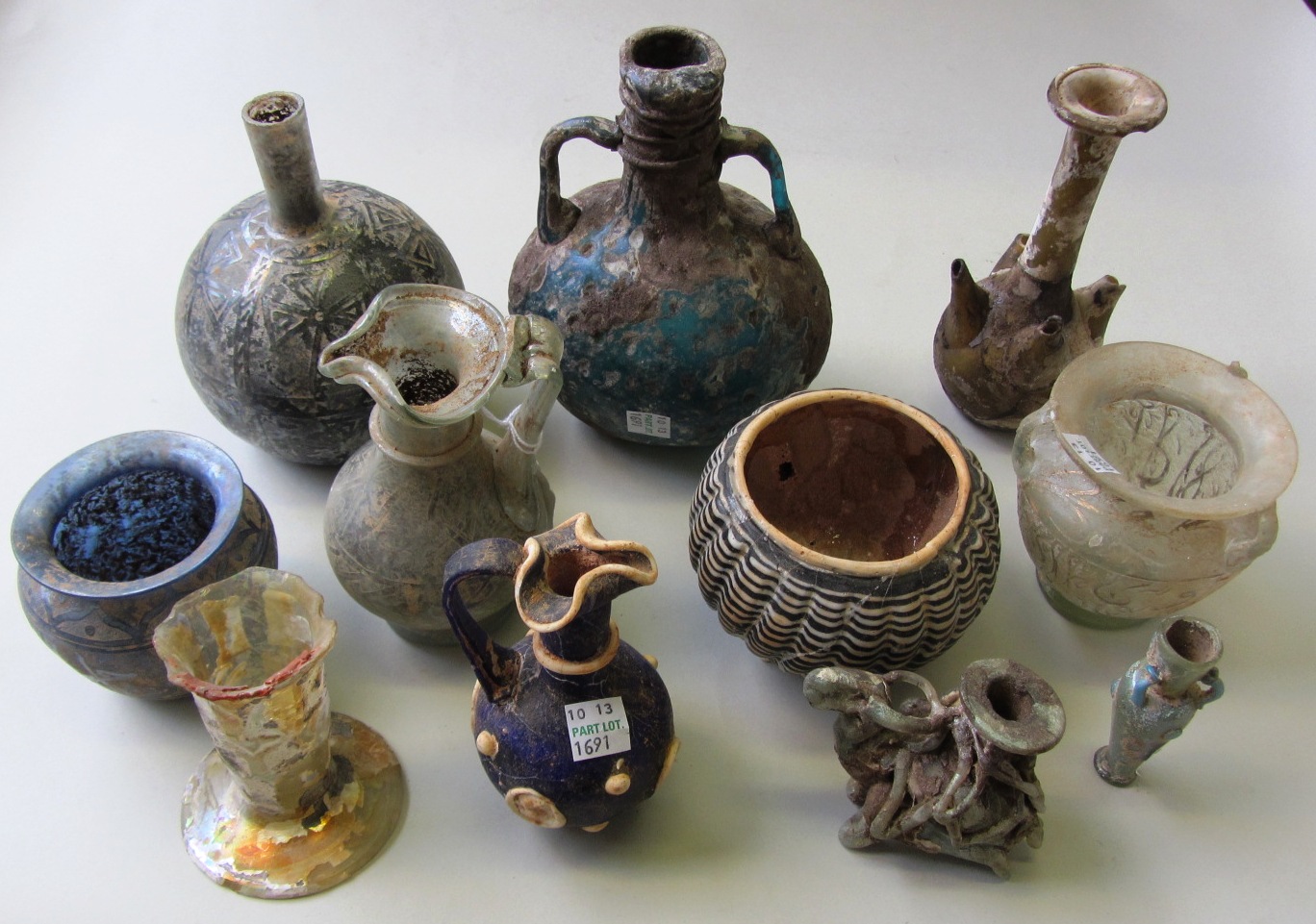 Appraisal: A group of Islamic-style glass vessels and two glass bottles