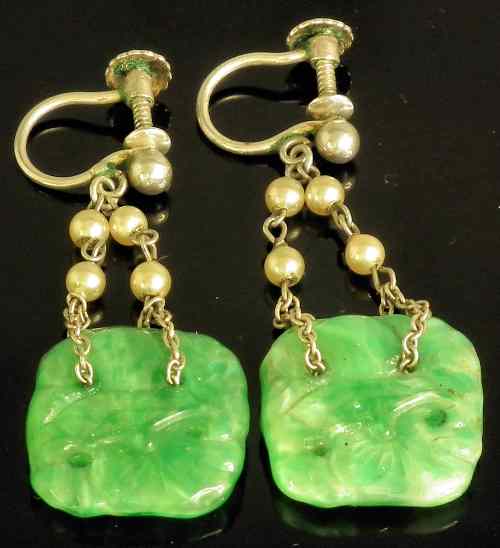 Appraisal: A pair of Chinese silvery metal mounted apple green jade