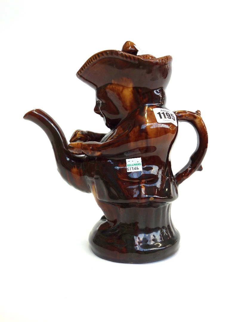 Appraisal: A Staffordshire pottery treacle glazed Snuff Taker toby teapot and