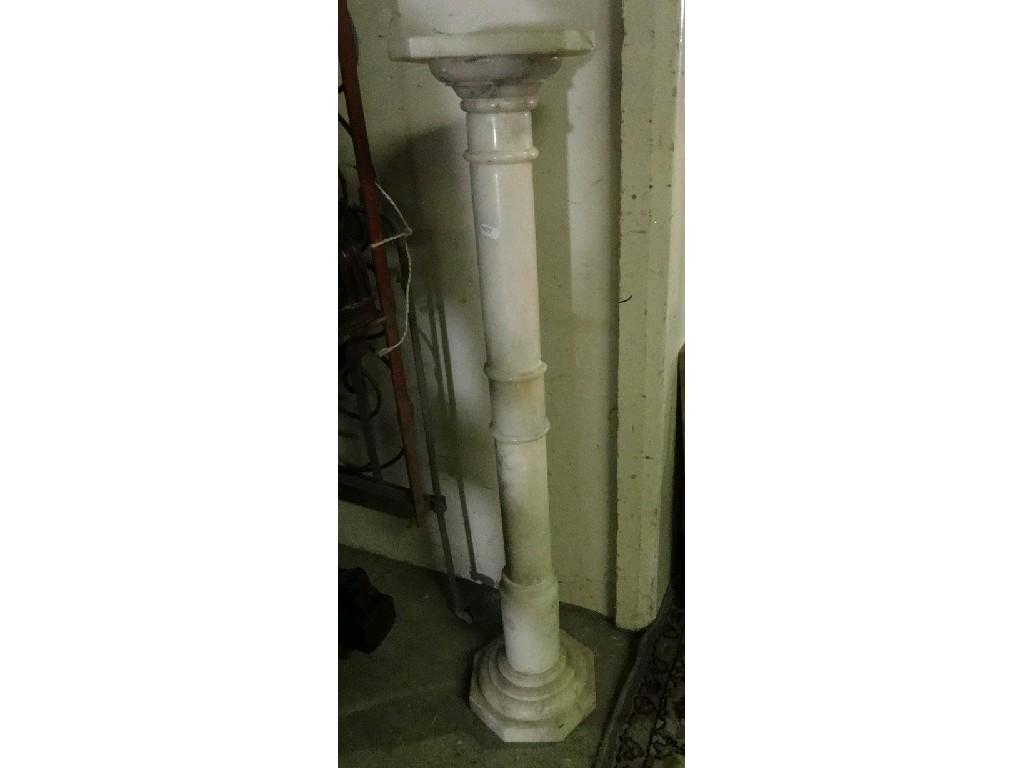 Appraisal: A simulated marble torchere with turned column stepped base and