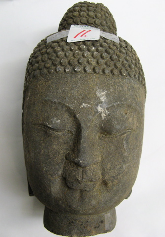 Appraisal: A GRANITE SCULPTED HEAD OF GAUTAMA BUDDHA having down cast