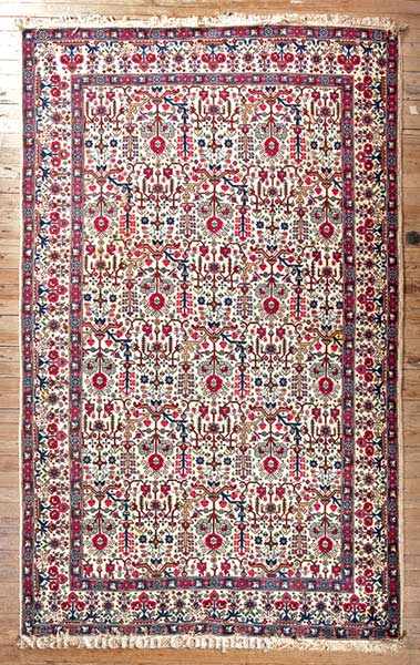 Appraisal: A Persian Carpet cream ground overall floral vine motif in