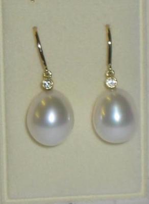 Appraisal: A PAIR OF CULTURED PEARL AND DIAMOND EARRINGS the ovoid