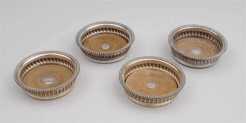 Appraisal: TWO PAIRS OF ENGLISH SILVER-PLATED BOTTLE COASTERS One marked with