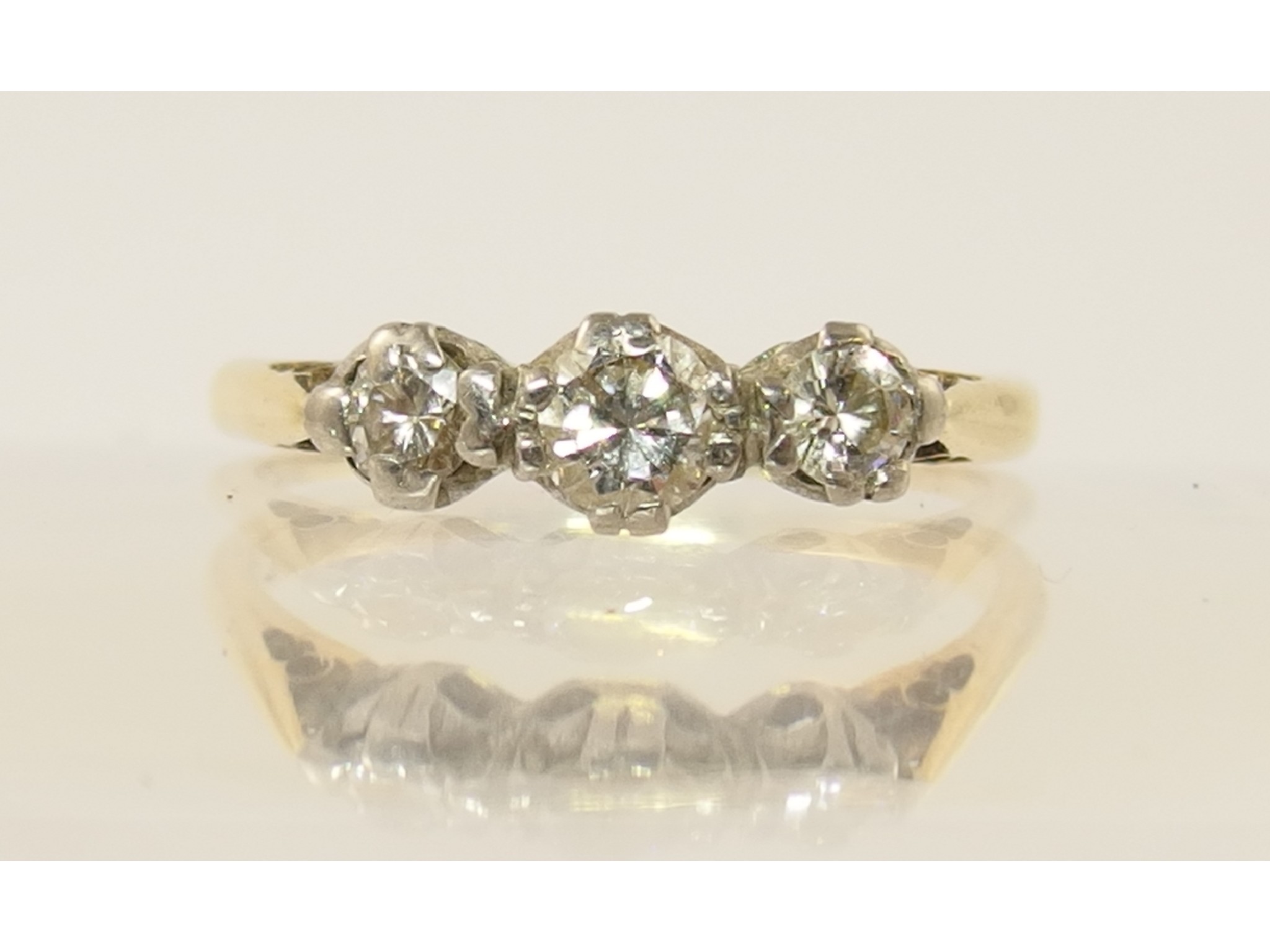 Appraisal: A yellow metal three stone diamond ring diamonds approx cts