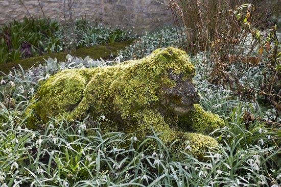 Appraisal: A reconstituted stone figure of a recumbent lion raised on