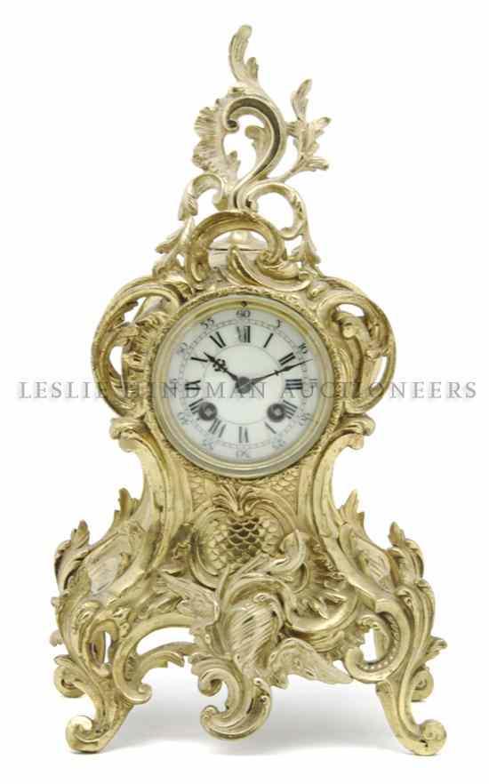 Appraisal: A Louis XV Style Brass Mantel Clock with scrolling foliate