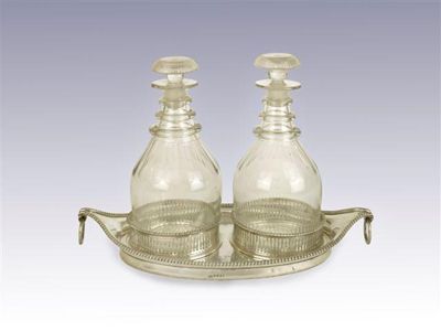 Appraisal: A George III boat-shaped decanter stand with gadrooned borders drop