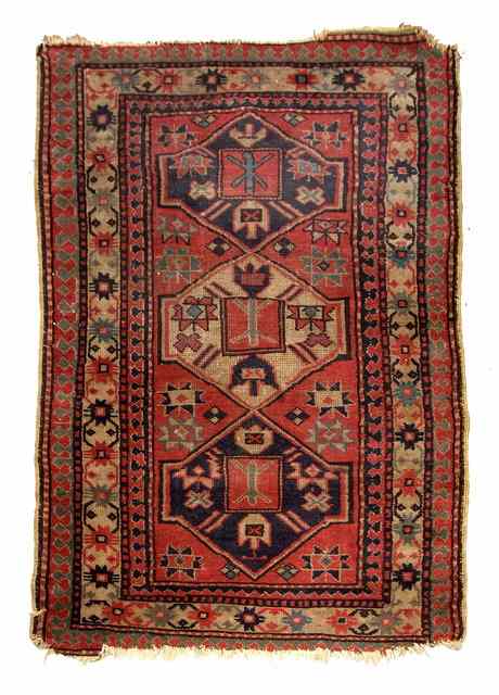 Appraisal: A PERGAM PINK GROUND RUG decorated a central triple medallion