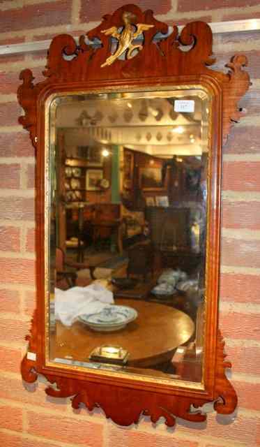 Appraisal: A GEORGIAN MAHOGANY FRET FRAME HANGING WALL MIRROR with gilt