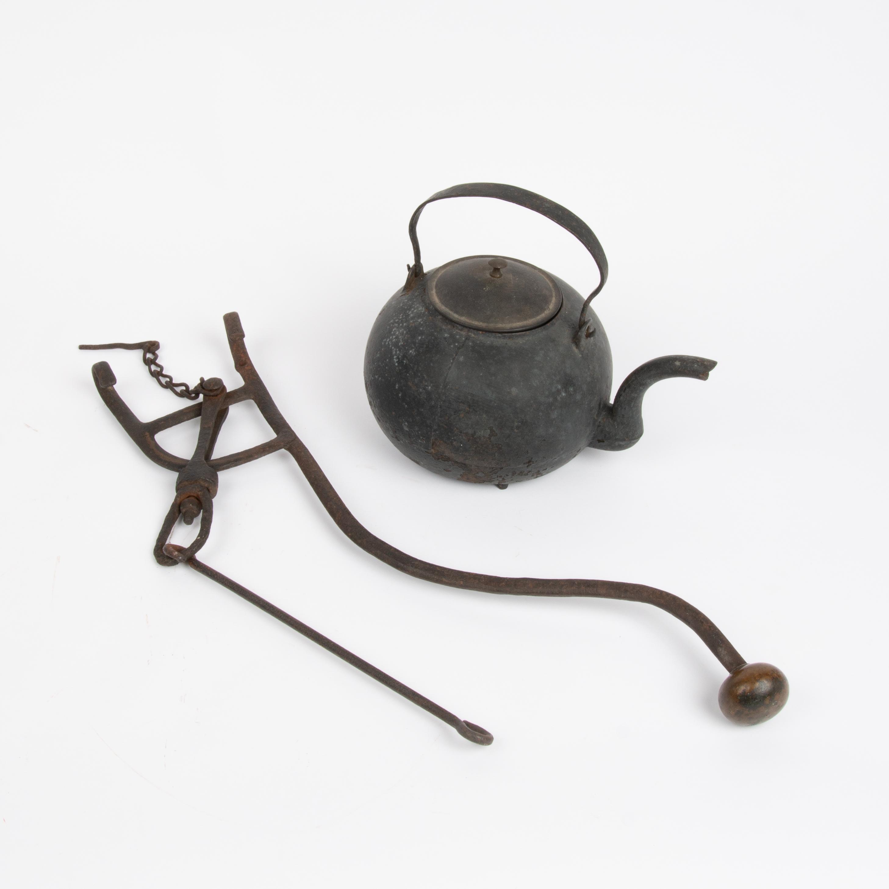 Appraisal: CAST IRON KETTLE WITH WROUGHT IRON HEARTH TILTER A wrought