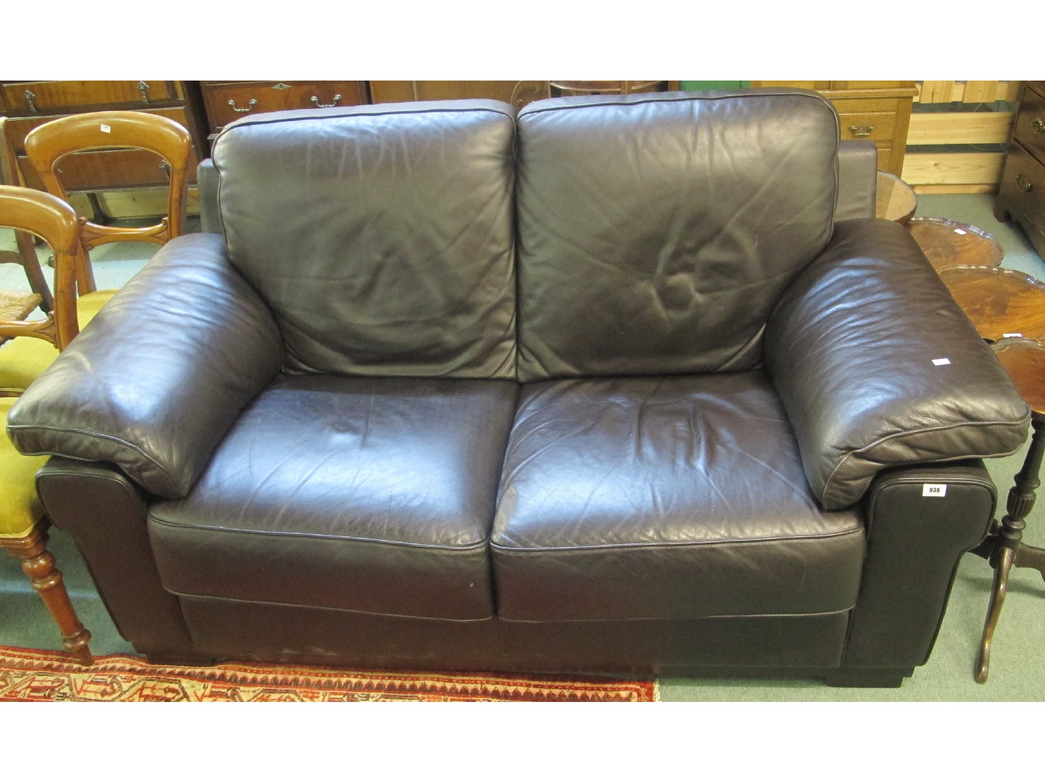 Appraisal: A black leather two seater settee