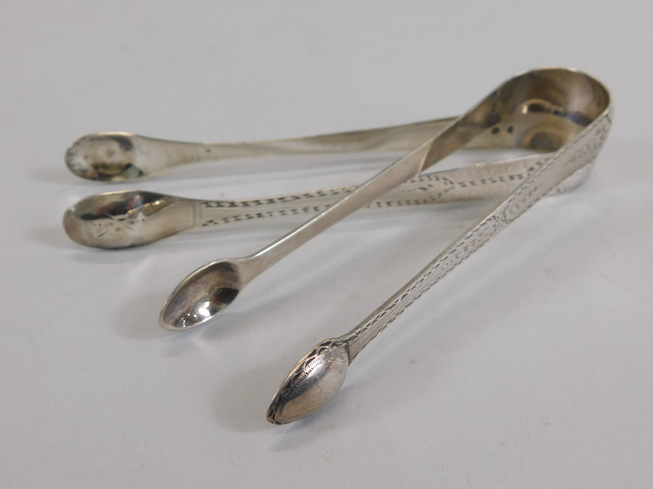 Appraisal: Two pairs of George III silver sugar tongs each with