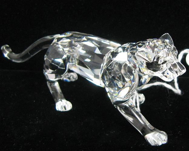 Appraisal: SWAROVSKI AUSTRIAN CUT CRYSTAL LEOPARD FIGURE with brown eyes faceted