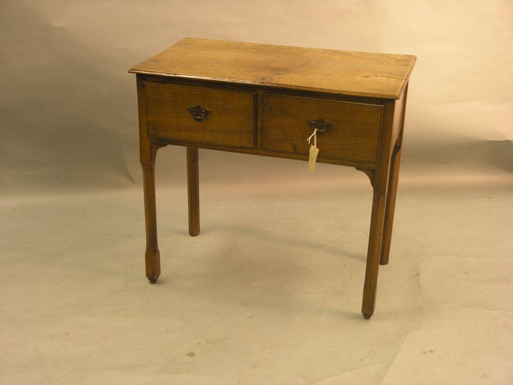 Appraisal: A George III oak side table with two drawers on