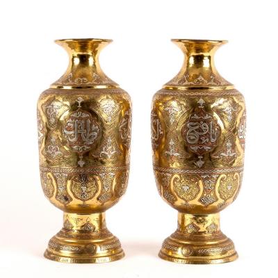 Appraisal: A pair of Eastern brass baluster vases inlaid script and