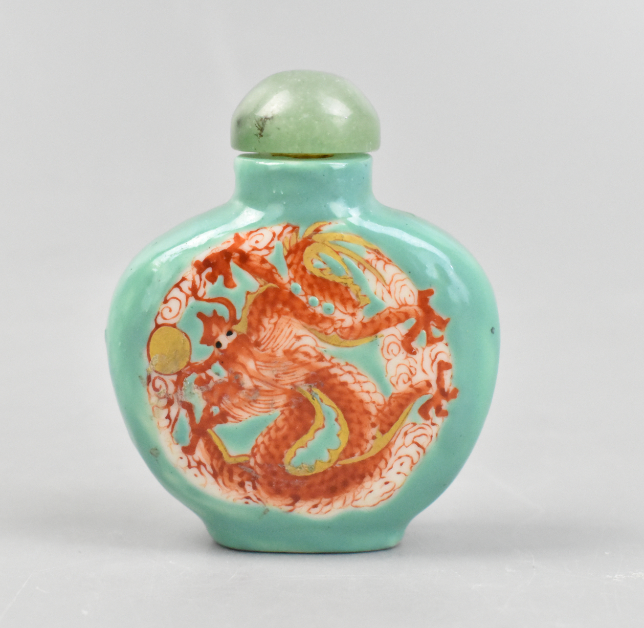 Appraisal: A Chinese turquoise iron red dragon snuff bottle Two sides