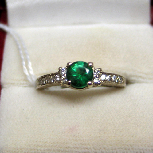 Appraisal: EMERALD DIAMOND AND FOURTEEN KARAT WHITE GOLD RING A round-cut