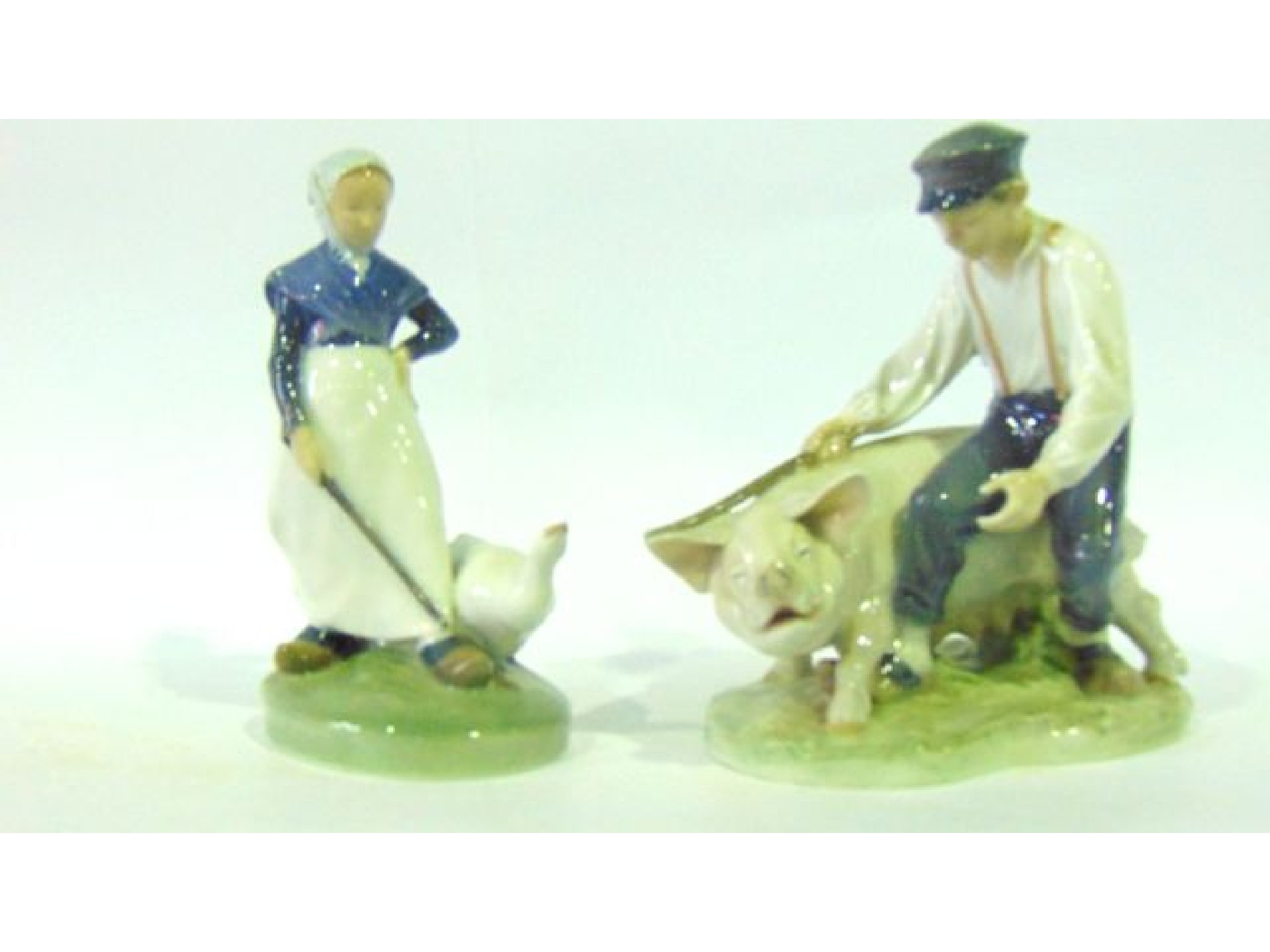 Appraisal: A Royal Copenhagen figure of a boy driving a sow