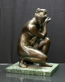 Appraisal: A bronze figure of a kneeling Venus mounted on a