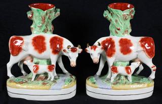 Appraisal: Pair of large Staffordshire spill vases each featuring a cow