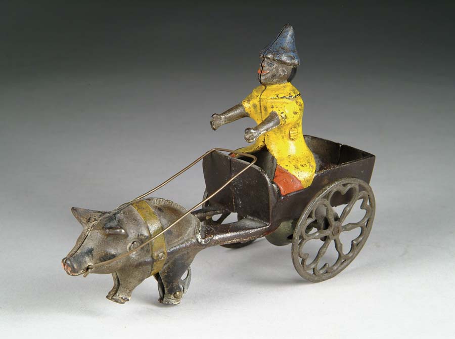 Appraisal: PIG AND CART WITH CLOWN DRIVER BELL TOY Manufactured by