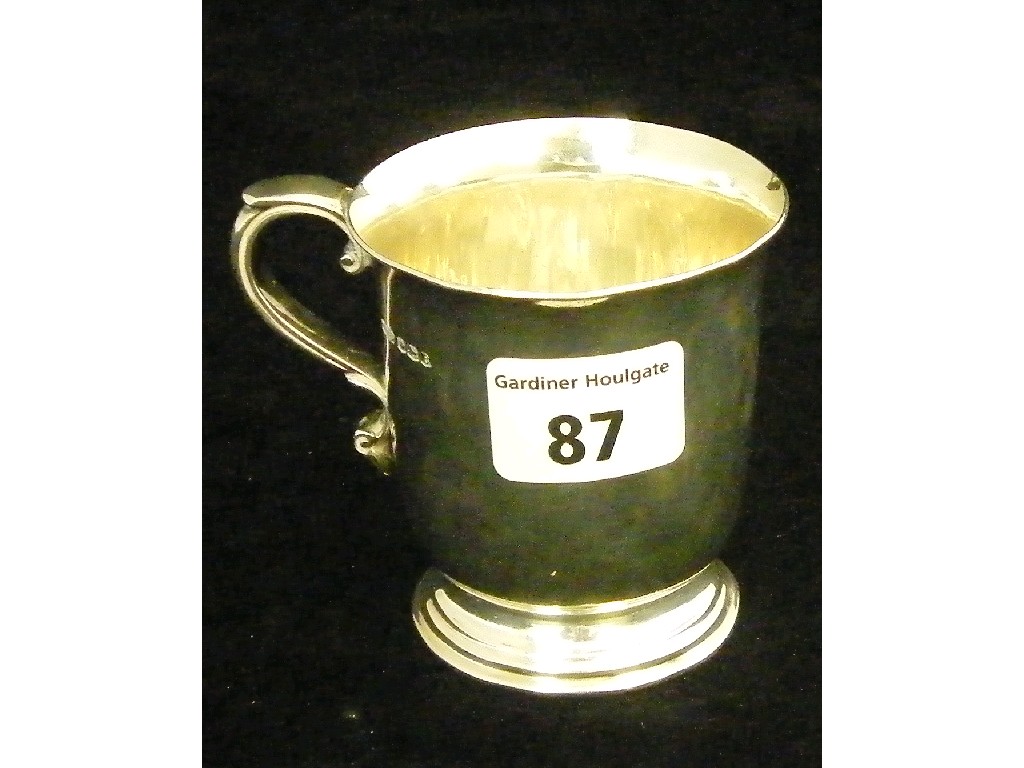 Appraisal: Christening mug with foliate scroll handle and a stepped foot