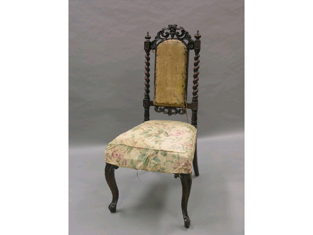 Appraisal: A Victorian walnut nursing chair with elaborate carved cresting on