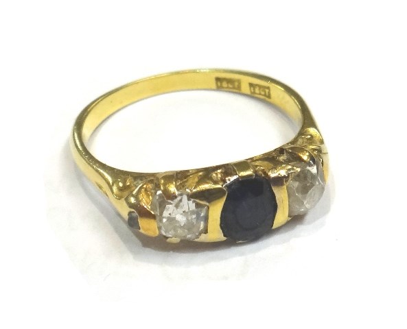 Appraisal: A gold diamond and sapphire set three stone ring mounted