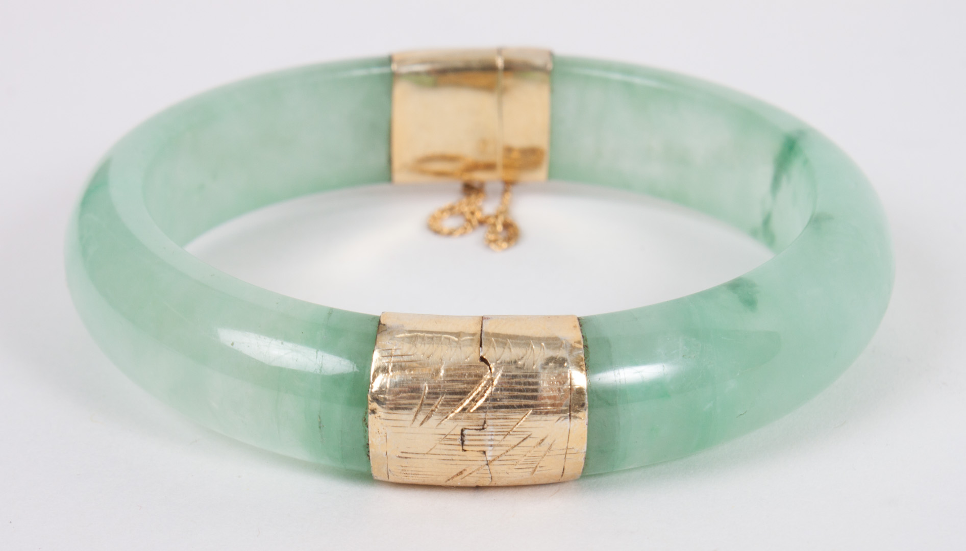 Appraisal: Chinese jade bangle bracelet with gold clasps in Diam