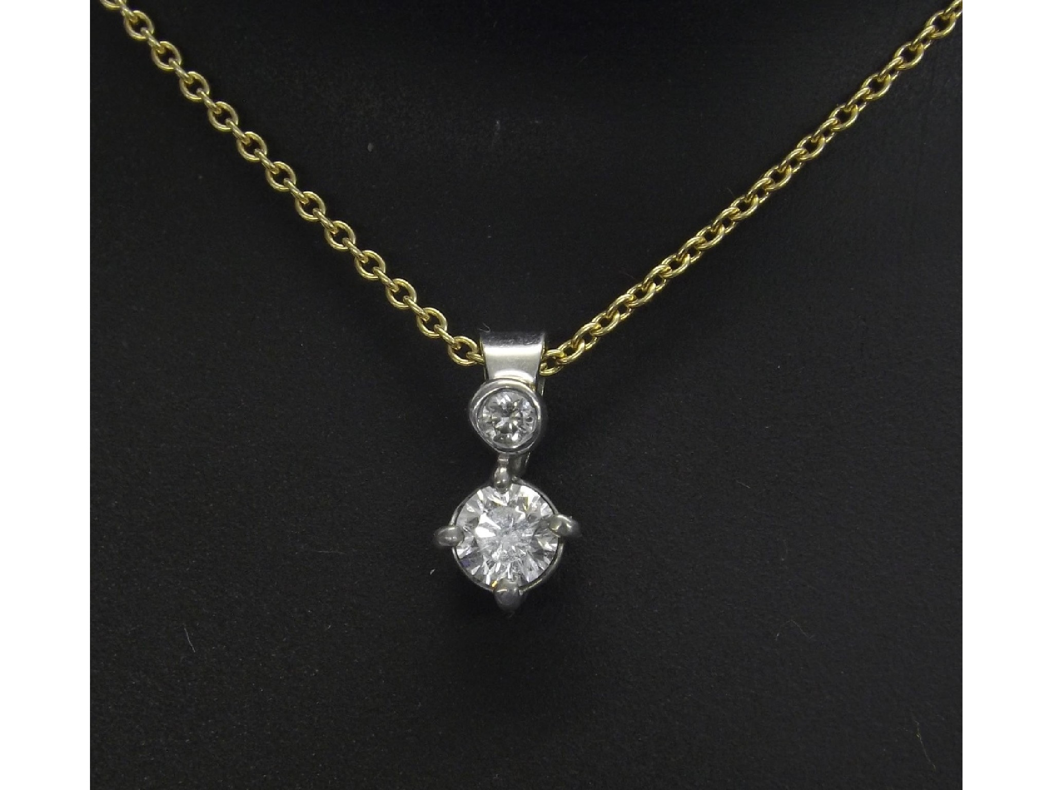 Appraisal: ct white gold two stone diamond pendant on a slender