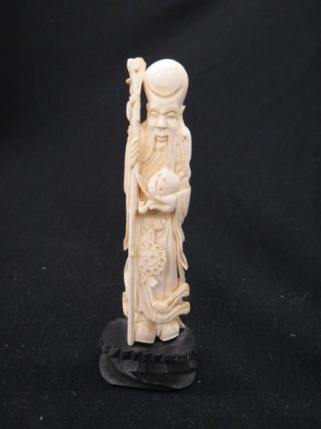 Appraisal: Carved Ivory Okimono of Figurine of animmortal holding a staff