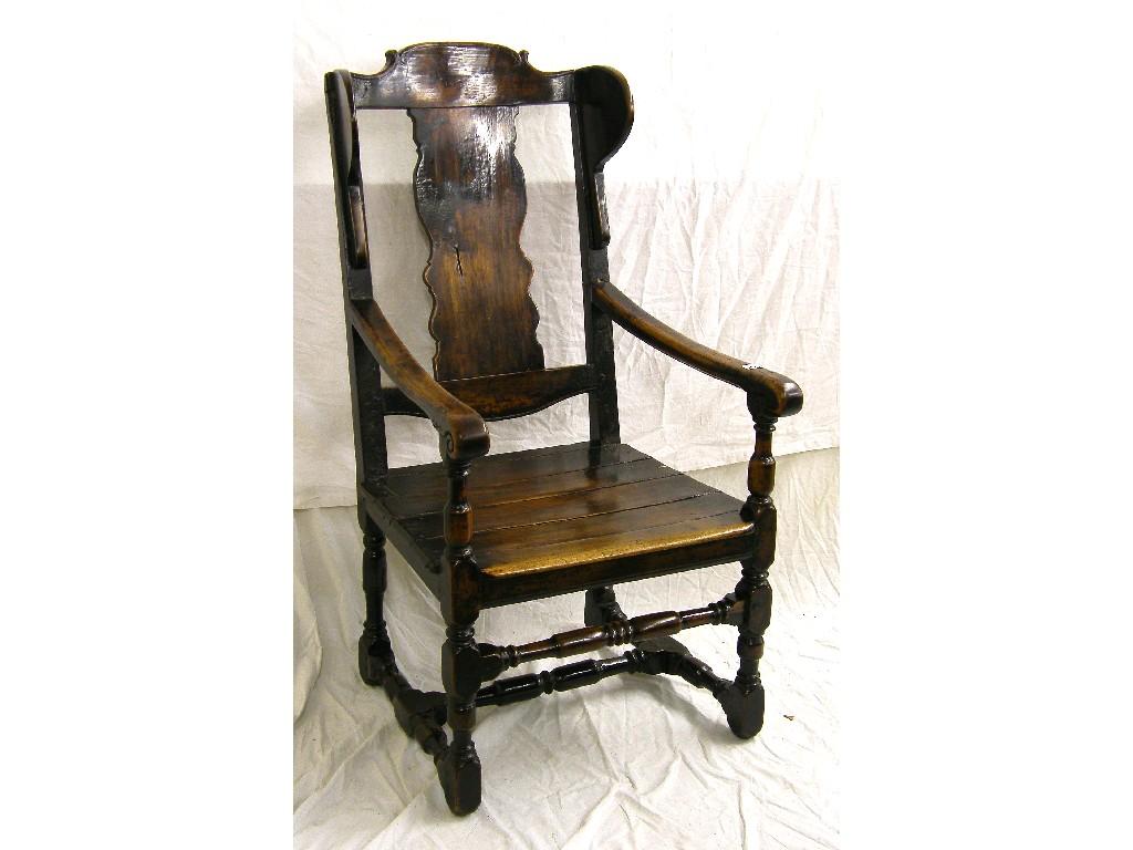 Appraisal: Large antique rustic walnut wing armchair the foliate shaped cresting