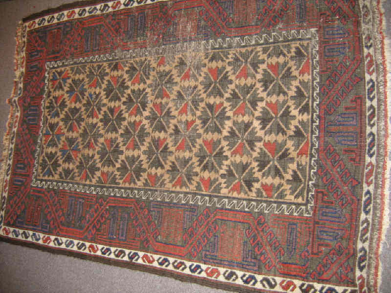 Appraisal: BELUCH THROW RUG The tan field shows an allover pattern