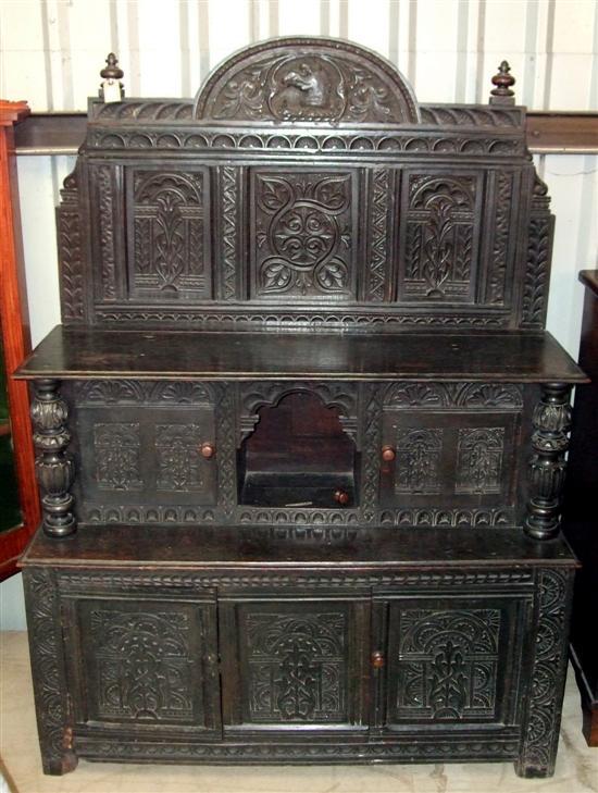 Appraisal: A th century dark oak side cabinet the shaped and