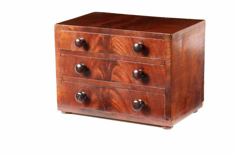 Appraisal: MINIATURE CHEST - Three-Drawer Miniature Chest in crotch mahogany veneer