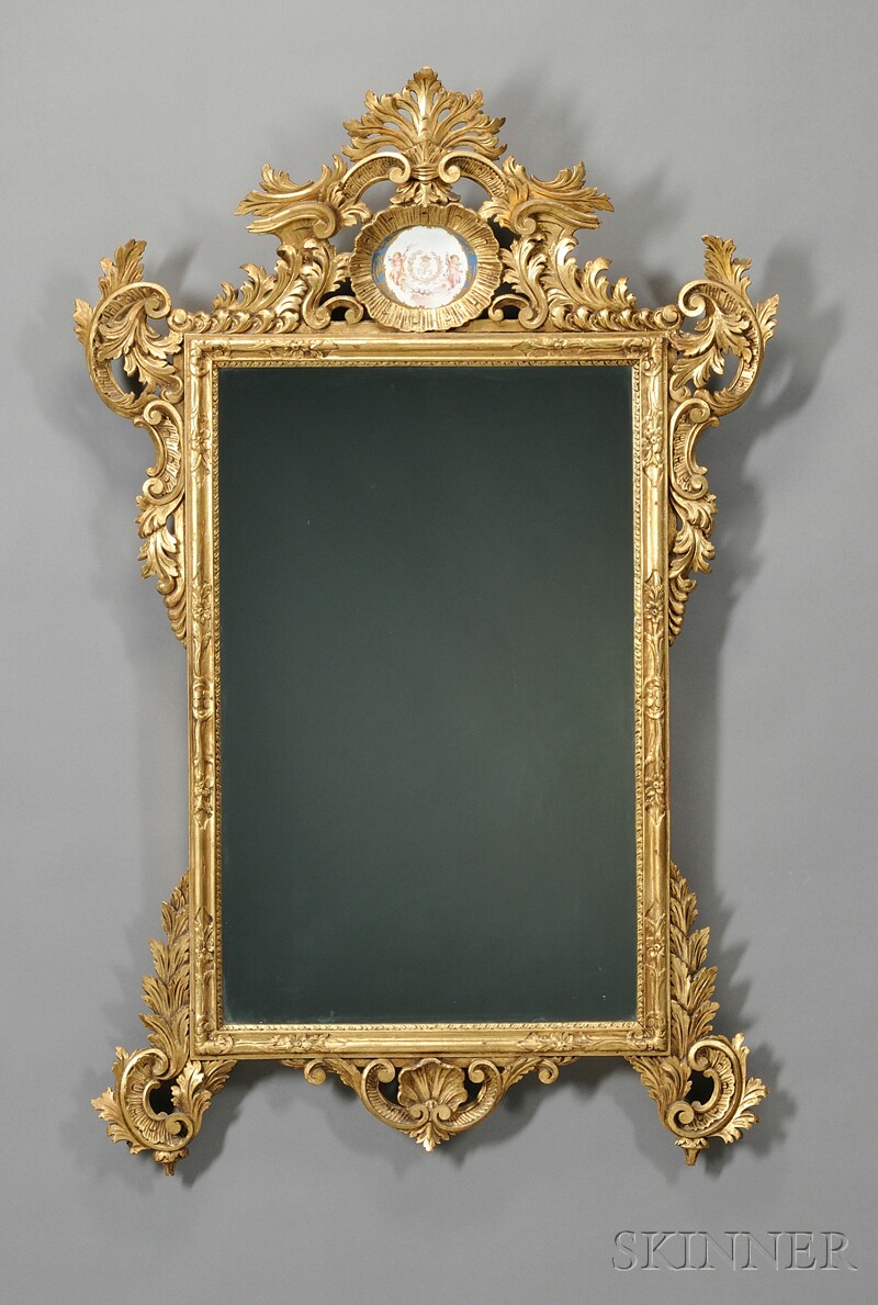 Appraisal: Sevres Porcelain-mounted Carved Giltwood Mirror the crest with scrolling acanthus