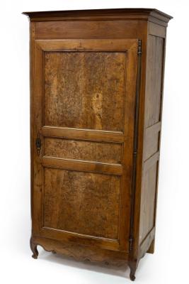 Appraisal: A French provincial walnut fruitwood and burr walnut armoire enclosed