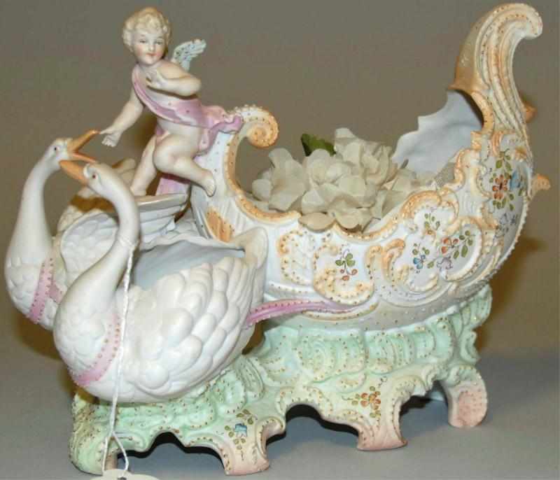 Appraisal: Bisque Cherub and Swans Figural Dish Two swans pulling cherub