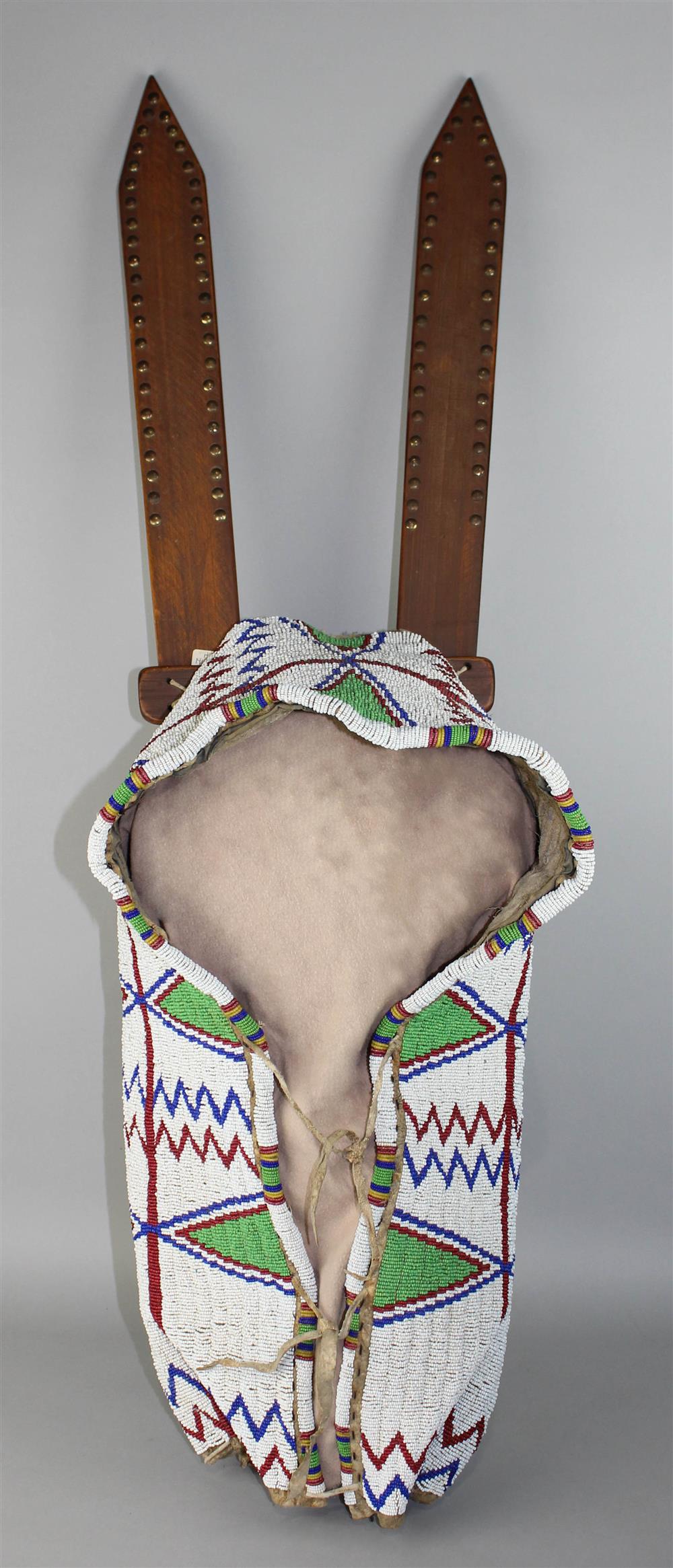 Appraisal: PLAINS BEADED HIDE AND TACKED CRADLEBOARD turn of the th