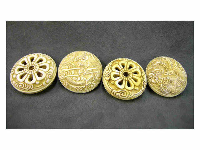 Appraisal: Four ivory manju with pierced chrysanthemum design on back three