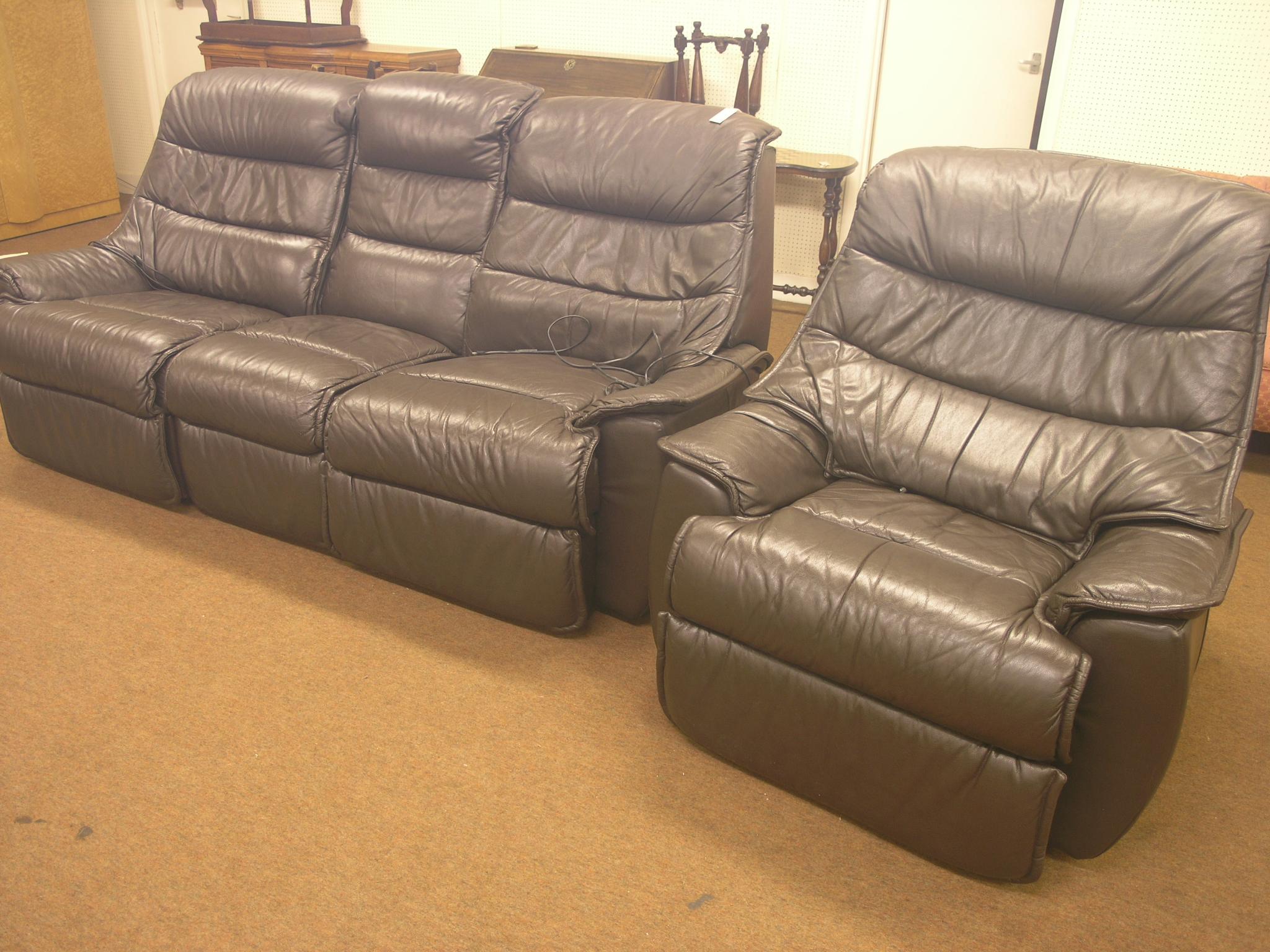 Appraisal: A modern brown leather settee and armchair both three-seater settee